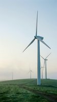 Wind turbines standing in green field at dawn, generating renewable energy for sustainable power production and clean electricity generation.
