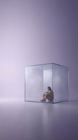 Young woman sitting inside transparent glass cube on purple gradient background representing isolation, confinement, mental health and emotional barriers.