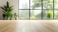 Empty modern room interior with large windows, wooden floor, and decorative potted plants creating bright minimalist space for yoga or meditation practice.