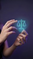 Hands protecting glowing digital scales of justice symbol representing legal protection, law firm services, and judicial balance in modern technology.