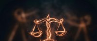 Glowing orange scales of justice symbol with intricate light trails against dark background for legal and law firm branding concepts.
