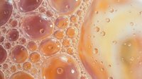 Abstract orange and yellow bubble foam texture with organic cellular pattern and translucent spheres creating modern artistic background for design projects.