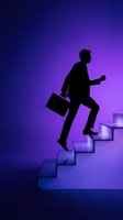 Silhouette of male professional climbing illuminated stairs while holding briefcase against purple gradient background, representing career advancement and business success.