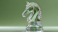 Crystal chess knight piece on green background, showcasing transparent glass craftsmanship with detailed equine features and strategic game element.
