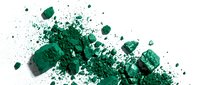 Crushed emerald green eyeshadow powder with scattered fragments and fine particles on white background, suitable for cosmetics, beauty, and makeup product photography.