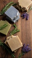Handmade natural soap bars with lavender flowers and rosemary herbs on rustic wooden background for spa wellness skincare and aromatherapy treatments.