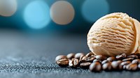 Coffee ice cream scoop on roasted coffee beans against blurred turquoise bokeh background, macro food photography with selective focus.