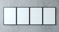 Four blank white canvas frames with black borders mounted on concrete wall for gallery exhibition or artwork display mockup.
