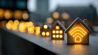 Glowing house shapes with wifi symbol illuminated in warm light against dark background with bokeh effect, smart home concept for technology and connectivity.