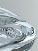 Abstract liquid mercury surface with smooth metallic waves and ripples creating dynamic flowing curves against light gray background for luxury design projects.