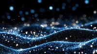 Glowing blue waves of light particles and bokeh effects on dark background create magical atmosphere for festive designs and holiday backgrounds.