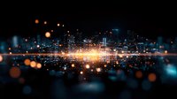 Digital city skyline with glowing orange light burst and bokeh effects against dark background, futuristic technology concept for business and innovation.