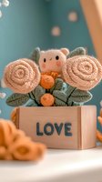 Cute plush toy arrangement with pink knitted roses and orange berries in wooden box with love text, soft focus romantic composition on turquoise background.