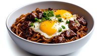 Korean beef bulgogi served over ramen noodles topped with fried eggs and fresh scallions in white bowl, Asian fusion comfort food meal ready to eat.