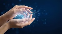 Hands holding glowing digital brain with neural network connections on dark blue background, representing artificial intelligence, technology innovation, and data processing for business solutions.