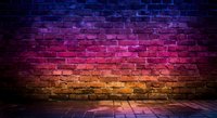 Vibrant neon gradient brick wall with purple pink orange lighting effects on dark urban background for modern design projects.