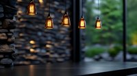 Glowing pendant lights illuminate dark stone wall creating cozy atmospheric ambiance in restaurant interior. Rustic design elements blend with modern decor.