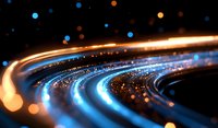 Glowing curved light trails with blue and orange bokeh effects against dark background create dynamic motion and energy flow for technology concepts.