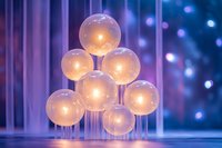 Glowing glass spheres arranged in geometric pattern with soft purple and blue bokeh background creating magical atmospheric lighting effect.