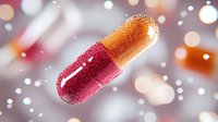 Glowing medical capsule pill in pink and orange colors floating on blurred bokeh background with light effects and particles. Healthcare concept.