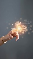 Hand holding glowing digital security shield and network icons with golden light effects against gray background for cybersecurity and data protection concepts.