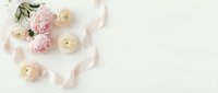 Soft pink peonies and cream ranunculus flowers with delicate petals scattered on white background for wedding invitations and romantic design projects.