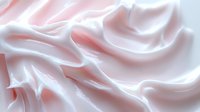 Soft pink and white silk fabric with elegant flowing waves and gentle folds creating luxurious textile background for fashion and beauty projects.
