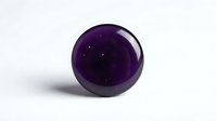 Polished amethyst sphere with glossy finish isolated on white background, suitable for jewelry, wellness, and crystal design projects.
