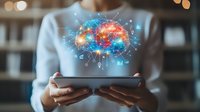Colorful digital brain hologram projecting from tablet held by woman, representing artificial intelligence and cognitive technology in modern workspace.