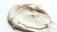 Creamy white cosmetic product with textured application strokes on isolated white background, suitable for skincare, beauty, and wellness design projects.