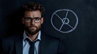 Caucasian businessman with beard and glasses standing near chalkboard with pie chart sketch. Dark moody professional portrait against black background for business concepts.