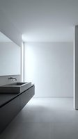 Modern minimalist bathroom interior with floating dark vanity and rectangular sink in clean white space for contemporary home design projects.