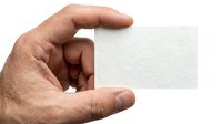 Male hand holding blank white business card mockup isolated on white background for corporate branding and contact information design projects.