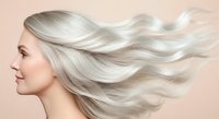 Woman with long, flowing silver hair against neutral background, ideal for hair care, beauty, and wellness marketing.