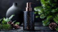 Black speckled soap dispenser with copper pump on dark background surrounded by pine branches and cones, creating luxurious bathroom atmosphere.