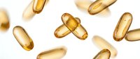 Golden vitamin capsules floating on white background isolated for health supplement design and medical wellness marketing materials.
