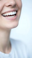 Close-up of woman's radiant smile showing perfect white teeth and healthy pink lips for dental care and oral hygiene advertising campaigns.