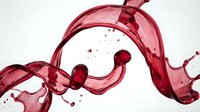 Red wine splash with flowing liquid motion and droplets on white background for beverage advertising and culinary design projects.