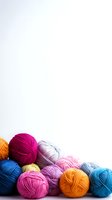 Colorful yarn balls in vibrant shades arranged on white background for crafting and knitting projects with copy space for text.