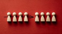 Wooden figures with arrow showing team transition or delegation concept on vibrant red background for business presentations.