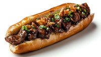 Gourmet steak sandwich with caramelized onions and herbs on crusty bread roll, perfect for restaurant menus and food photography projects.
