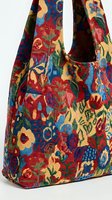 Colorful tapestry tote bag with vibrant floral pattern featuring roses and decorative motifs in red, blue, yellow and green hues on white background.