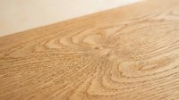Natural oak wood grain texture surface with warm brown tones and organic patterns for flooring, furniture and interior design projects.