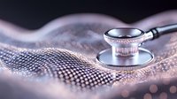Medical stethoscope on shimmering fabric with soft bokeh effect and selective focus, representing healthcare and medical examination in modern setting.