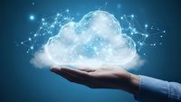 Business hand presenting glowing cloud computing network with connected data points on blue background for technology and digital transformation concepts.