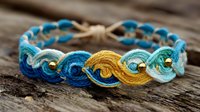 Handcrafted macrame bracelet with blue, turquoise, and yellow threads featuring gold beads on rustic wooden background, perfect for bohemian fashion accessories.