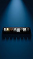 Keyboard keys spelling "ABCDEFG" in metallic finishes arranged on black holder against blue gradient background with dramatic lighting.