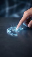 Caucasian male hand touching glowing holographic interface with circular digital elements on dark surface for technology and innovation concepts.