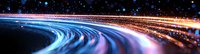 Curved light trails creating dynamic motion effect against dark background with glowing particles and streaks in blue and orange colors forming abstract panoramic view.