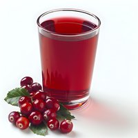 Fresh cranberry juice in clear glass with ripe berries and green leaves on white background, healthy antioxidant drink for natural wellness and immunity.